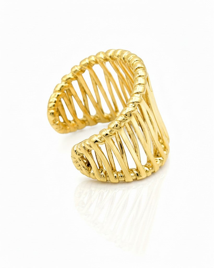 Elli Jewellery gold plated hollow geometric statement ring with a cage-like open design on a white background.