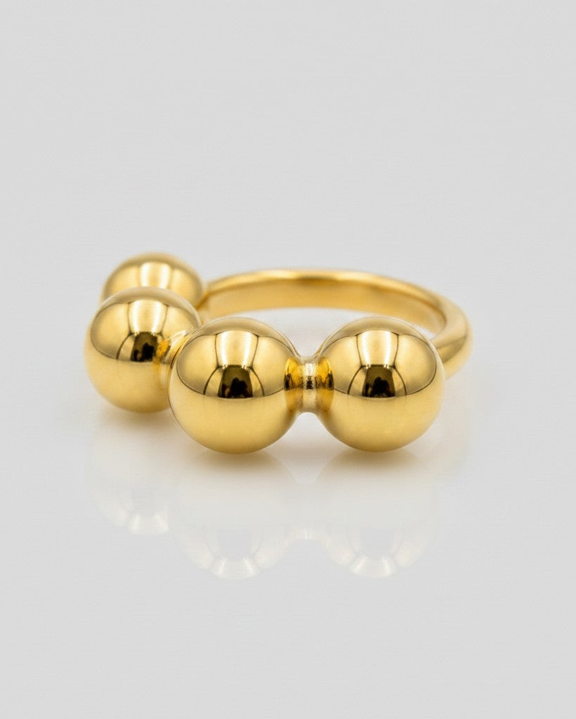 Elli Jewellery gold plated statement ring featuring a row of polished graduated spheres in a sculptural design.