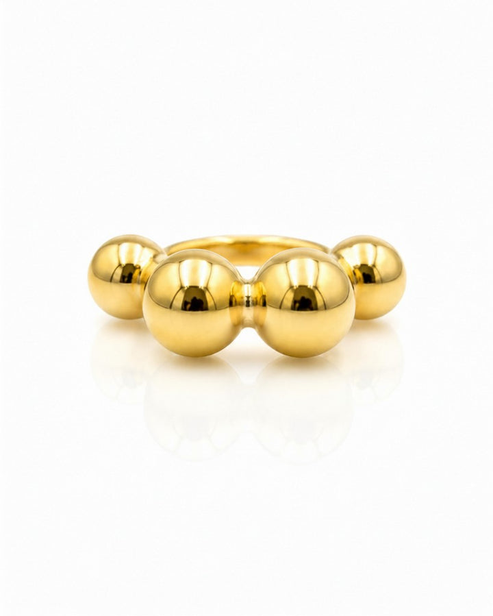 Elli Jewellery gold plated statement ring featuring a row of polished graduated spheres in a sculptural design.