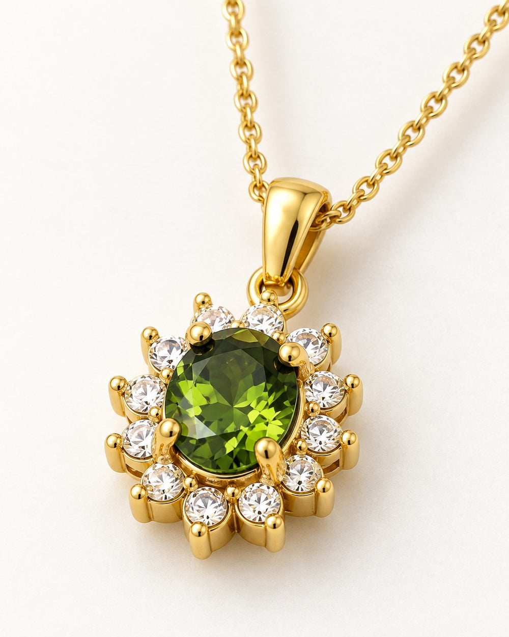 Elli Jewellery gold plated necklace featuring a central emerald green crystal surrounded by clear stones