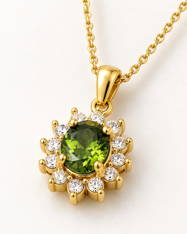 Elli Jewellery gold plated necklace featuring a central emerald green crystal surrounded by clear stones