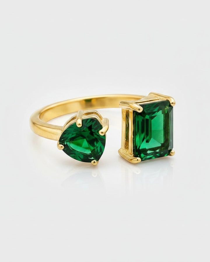 Elli Jewellery gold plated adjustable ring featuring a green emerald-cut and a heart-shaped cubic zirconia crystal.