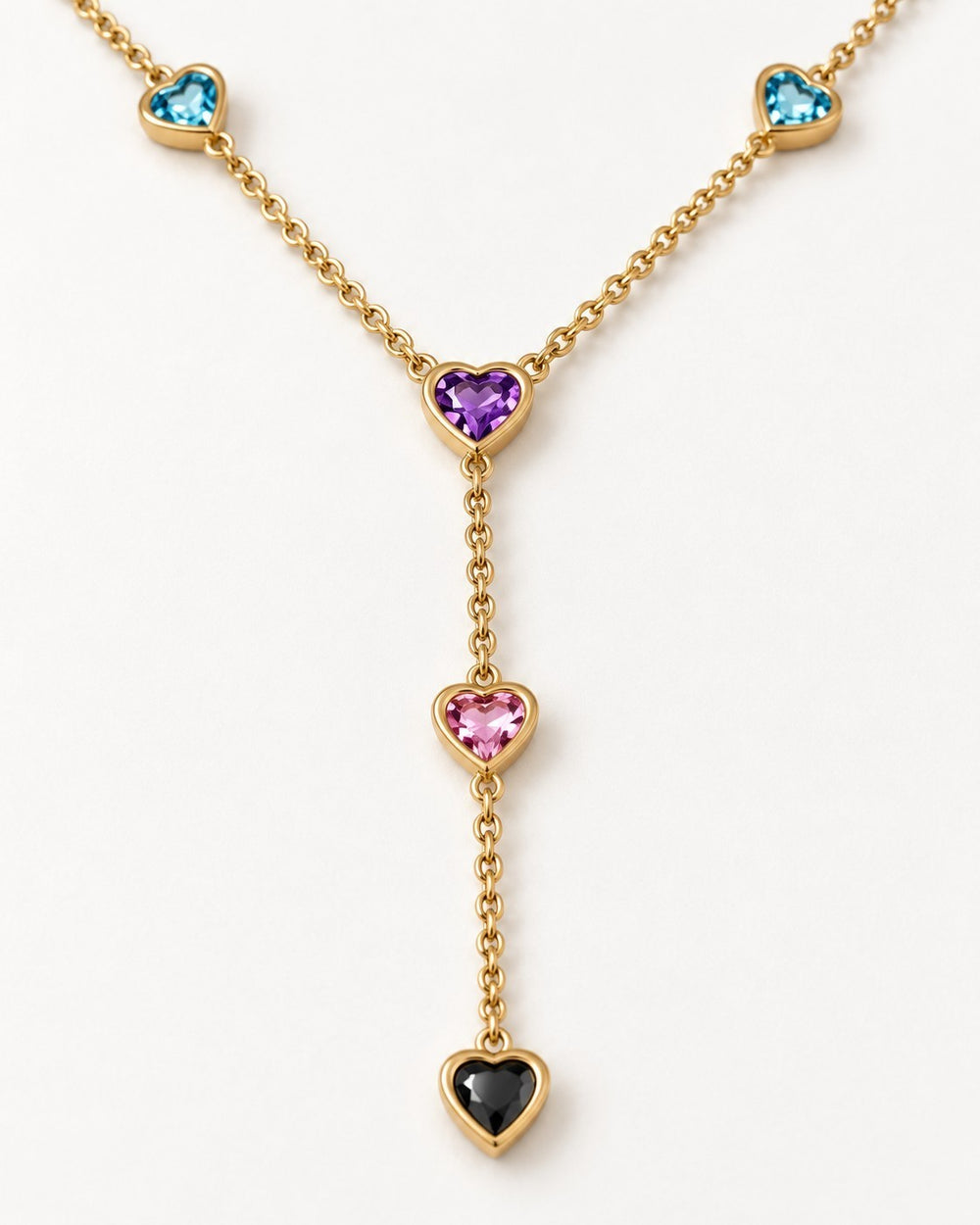 Elli Jewellery gold-plated Y-shaped necklace featuring colourful heart-shaped beads in blue, purple, pink, and black.