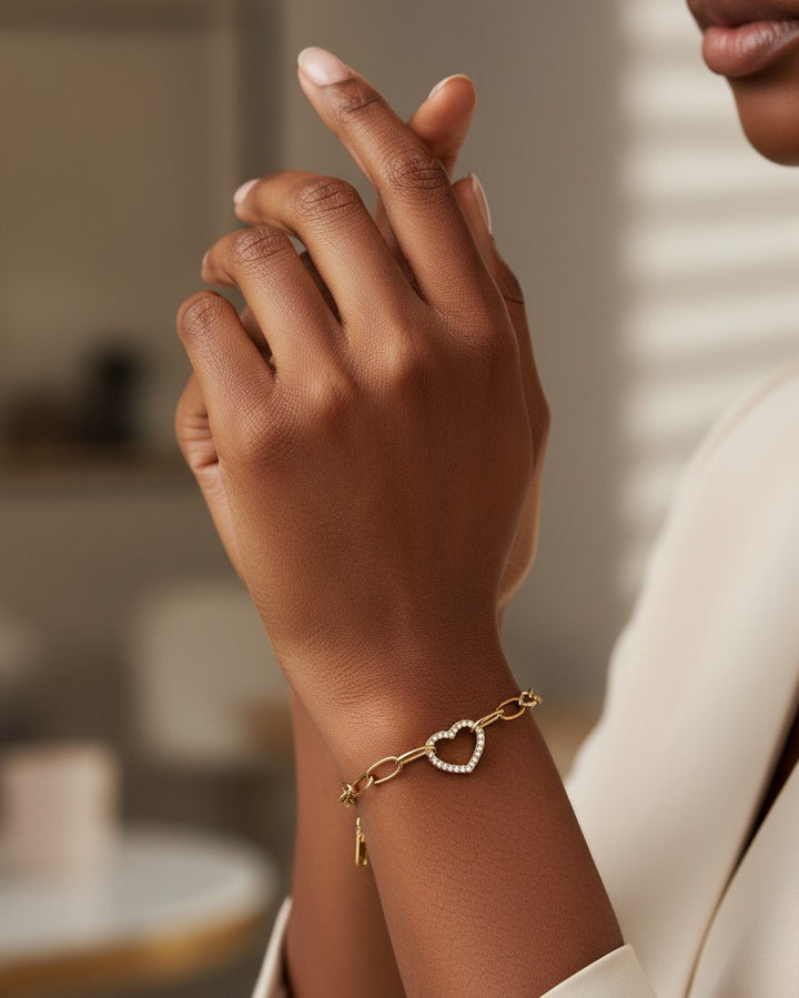 Elli Jewellery gold plated waterproof bracelet featuring a hollow heart charm with sparkling diamanté accents.