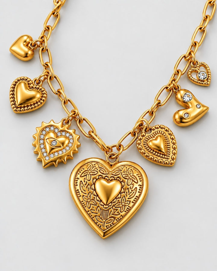 Elli Jewellery gold plated charm necklace featuring multiple heart-shaped pendants with intricate engravings and crystals