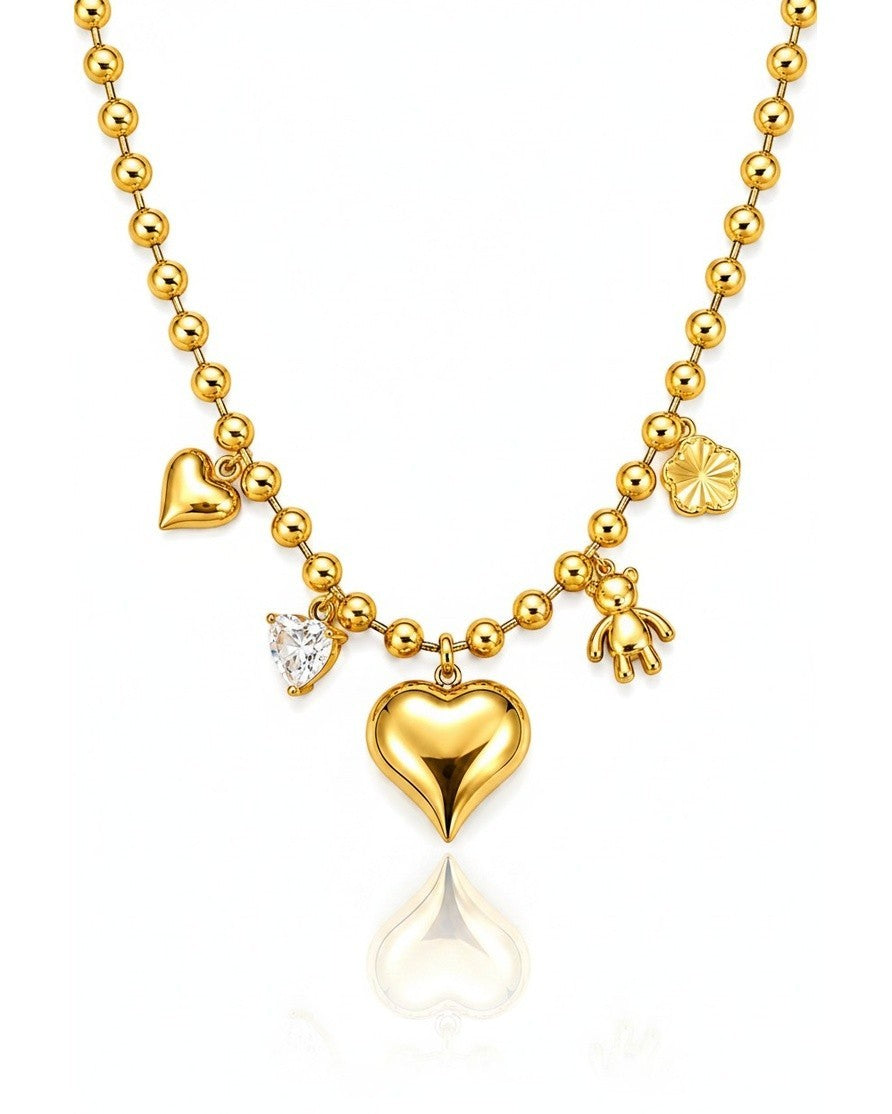 Elli Jewellery gold plated beaded chain necklace featuring a central heart charm, teddy bear, and crystal accents.