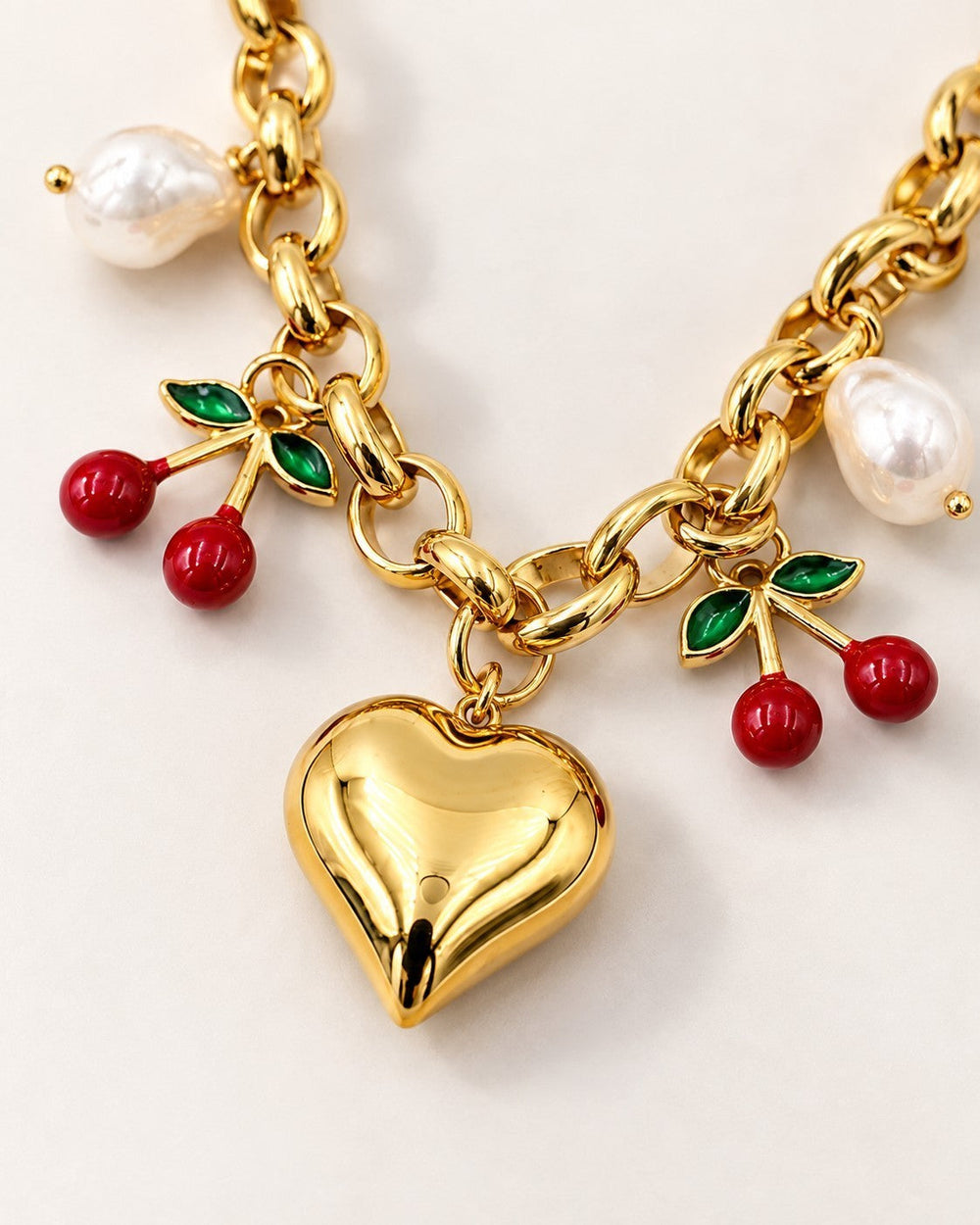 Elli Jewellery gold plated chain necklace featuring a heart charm, cherry charms, and white pearls.
