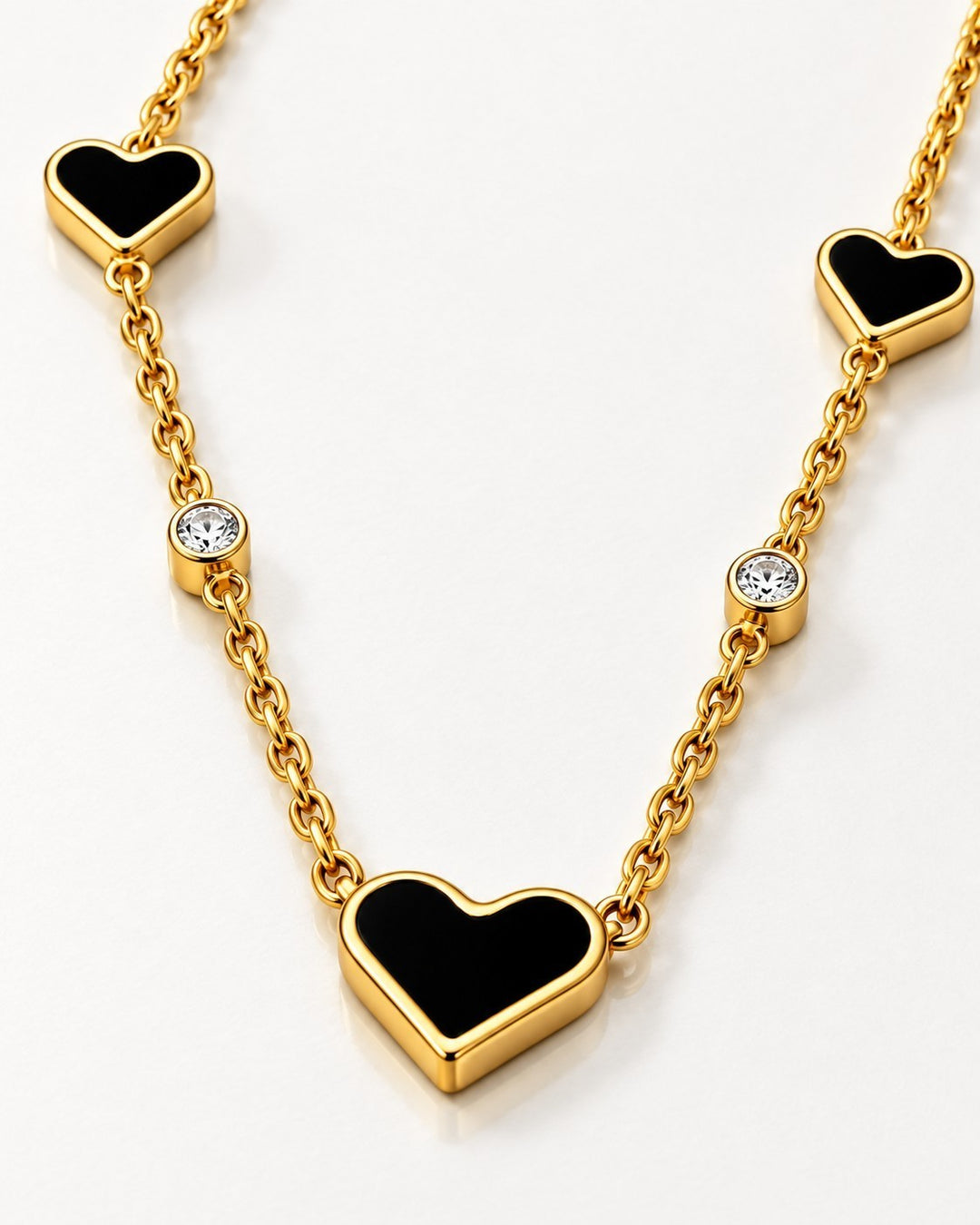Elli Jewellery gold plated necklace featuring black heart pendants and sparkling round crystals on a delicate chain