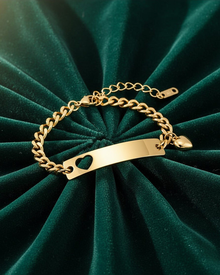 Elli Jewellery gold plated waterproof ID bracelet featuring a delicate heart cutout on a sleek chain link design