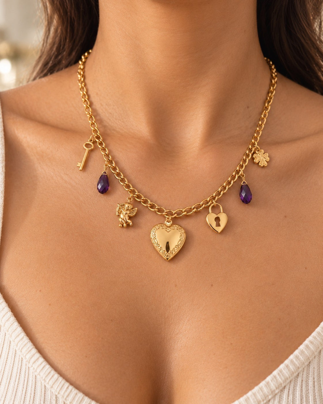 Elli Jewellery gold plated charm necklace featuring a heart locket, purple crystals, and delicate key charms.
