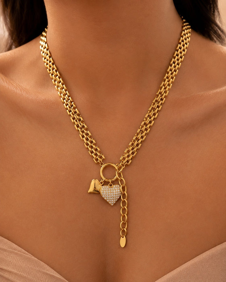 Elli Jewellery gold plated waterproof necklace featuring a textured chain and two heart charms with crystal accents.
