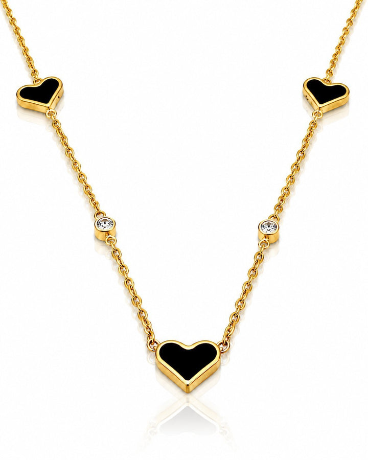 Elli Jewellery gold plated necklace featuring three darkened heart pendants and two clear stones on a delicate chain