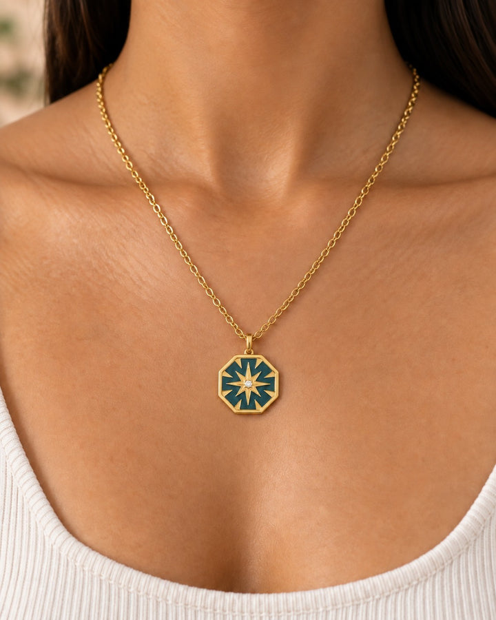 Elli Jewellery gold plated hexagon necklace with mint green enamel and a central star detail worn on a model