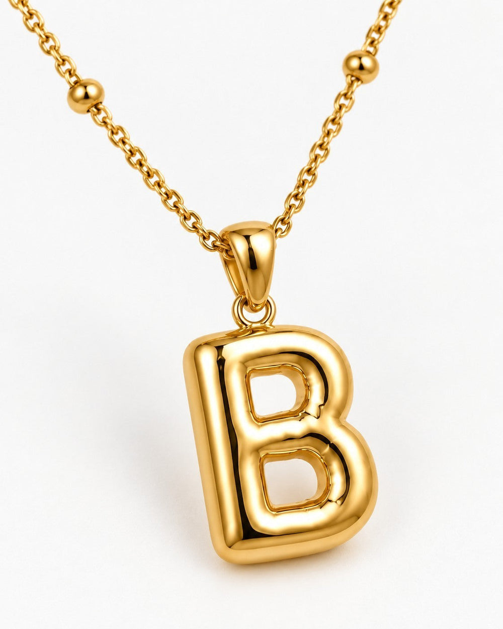 Elli Jewellery gold plated chunky initial B pendant necklace on a delicate beaded chain against a white background.