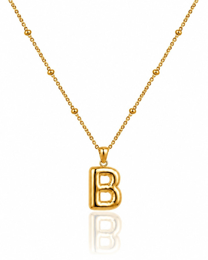Elli Jewellery gold plated chunky initial B pendant necklace on a delicate beaded chain against a white background