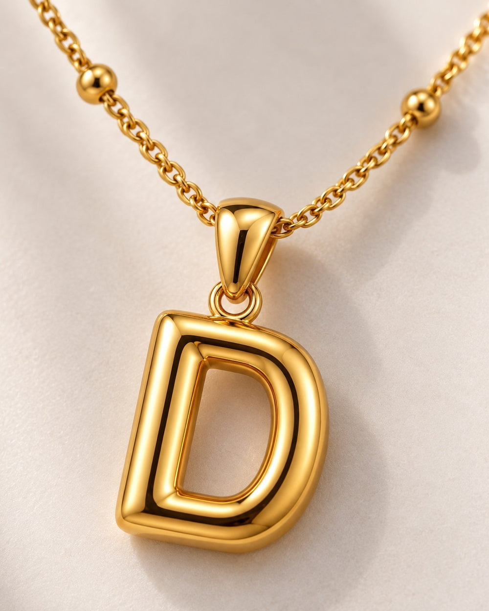 Elli Jewellery gold plated chunky initial D letter pendant necklace on a delicate beaded chain.