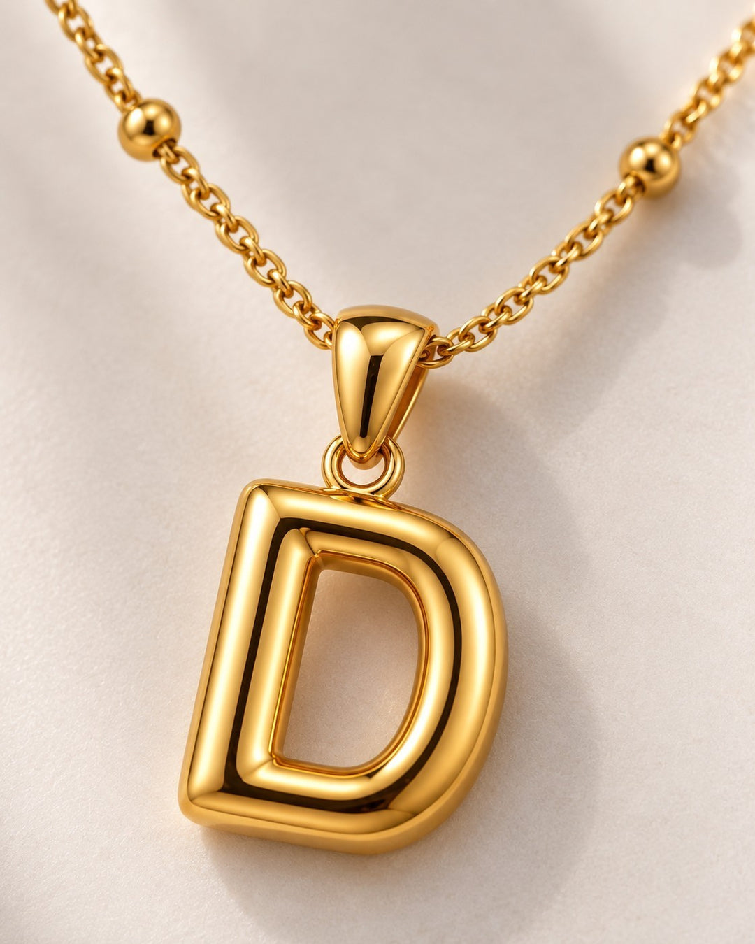 Elli Jewellery gold plated chunky initial D letter pendant necklace on a delicate beaded chain.