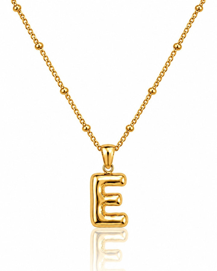 Elli Jewellery gold plated chunky initial E pendant necklace on a beaded chain against a white background