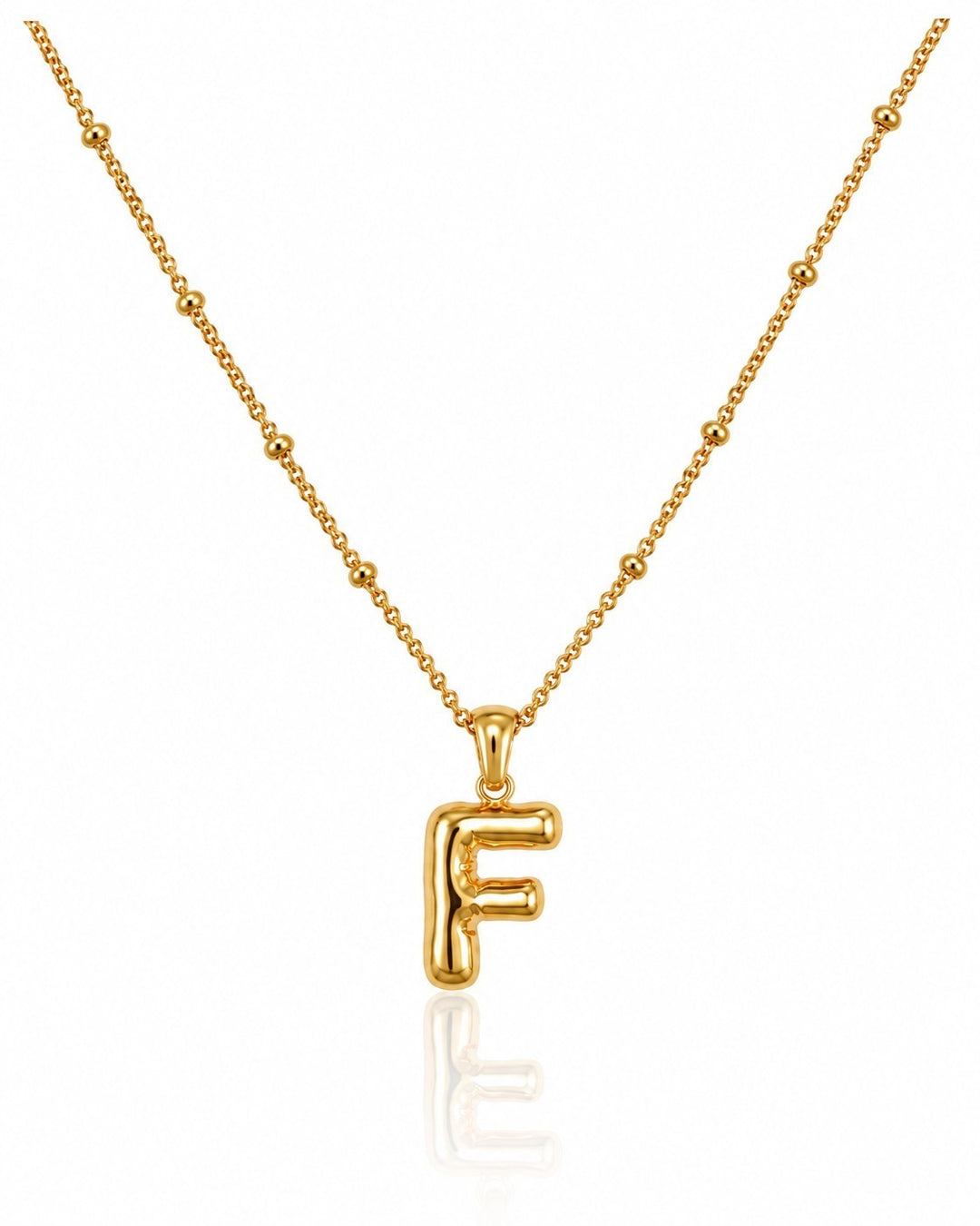 Elli Jewellery gold plated chunky initial F pendant necklace on a delicate beaded chain against a white background