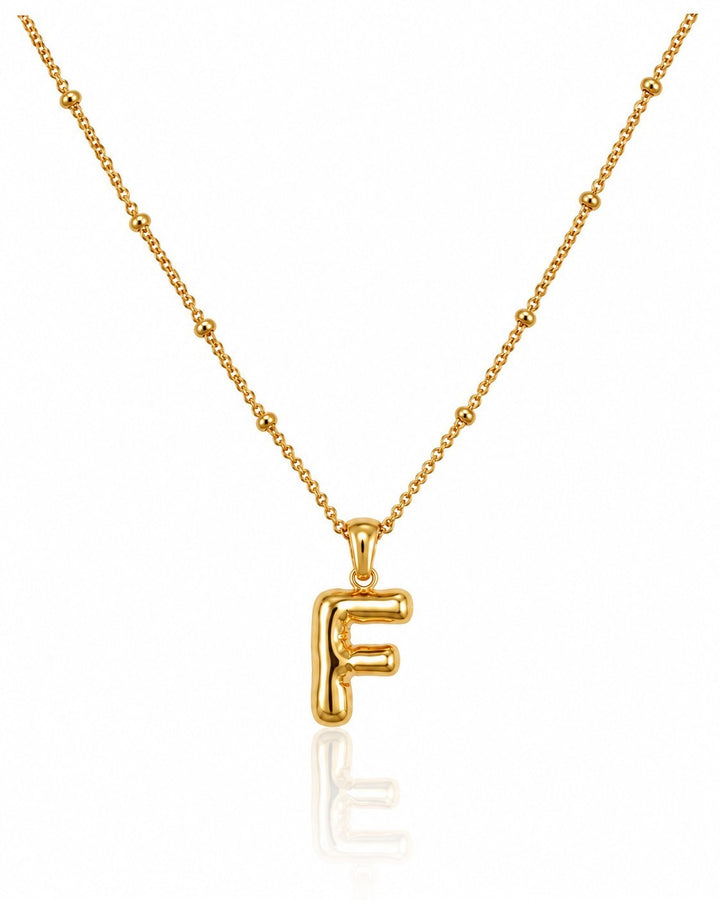 Elli Jewellery gold plated chunky initial F pendant necklace on a delicate beaded chain against a white background