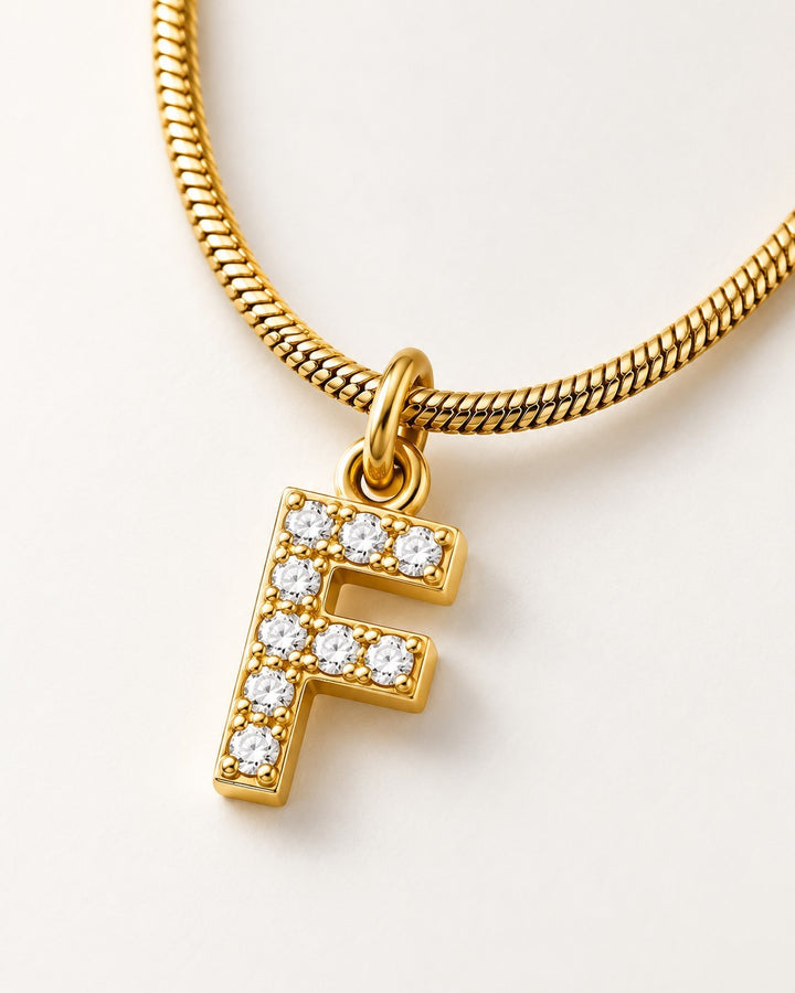 Elli Jewellery gold plated initial F pendant necklace with sparkling cubic zirconia stones on a delicate snake chain.