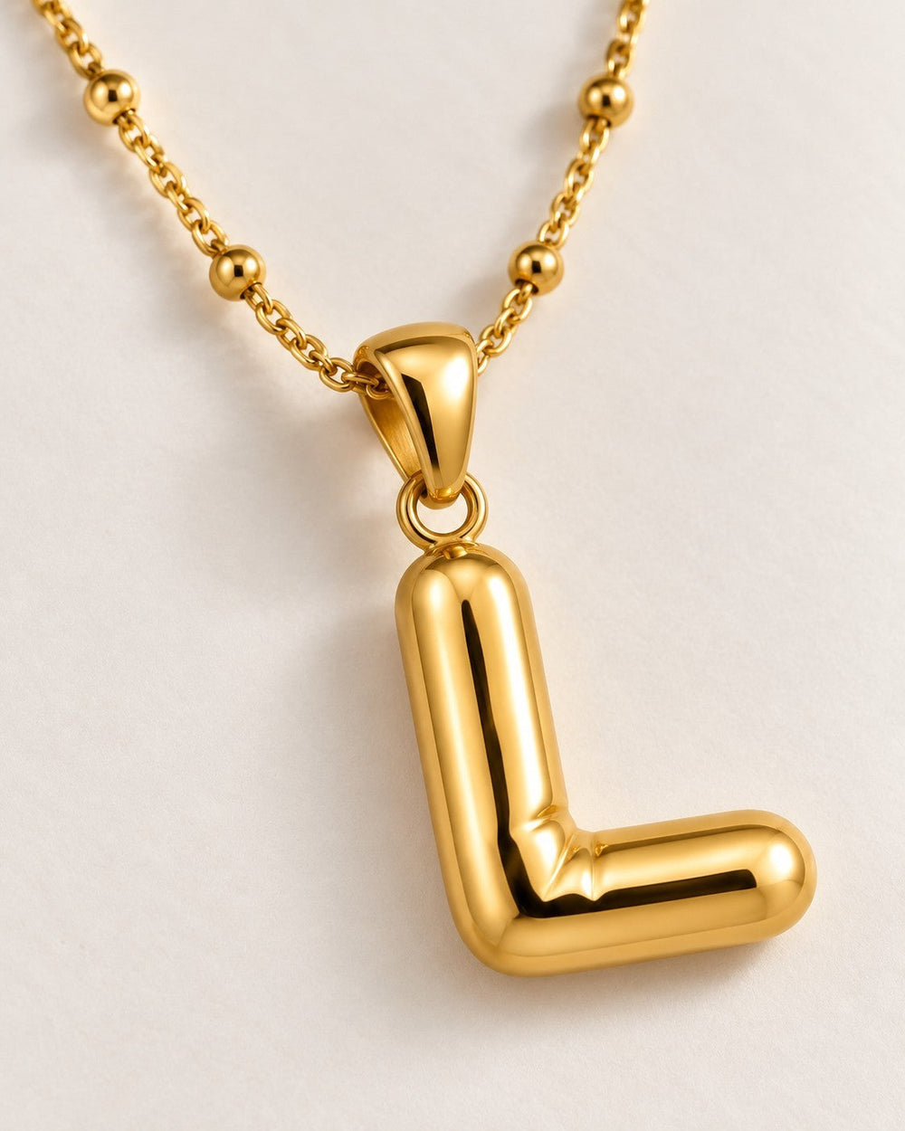 Elli Jewellery gold plated chunky chain necklace featuring a polished letter L pendant on a beaded link chain.