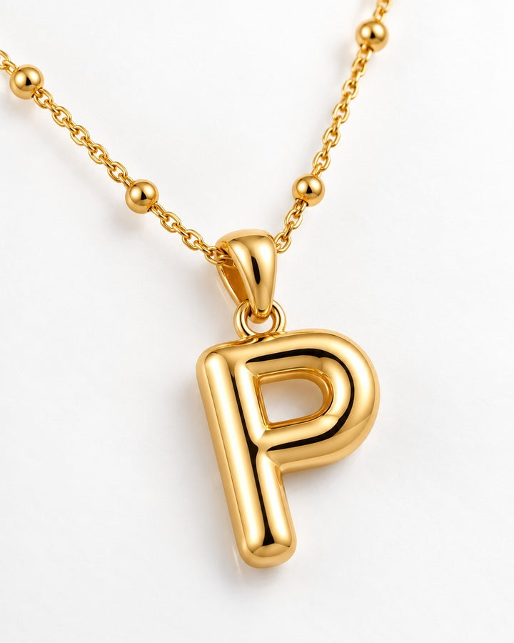 Elli Jewellery gold plated chunky initial P pendant necklace on a delicate beaded chain against a white background.