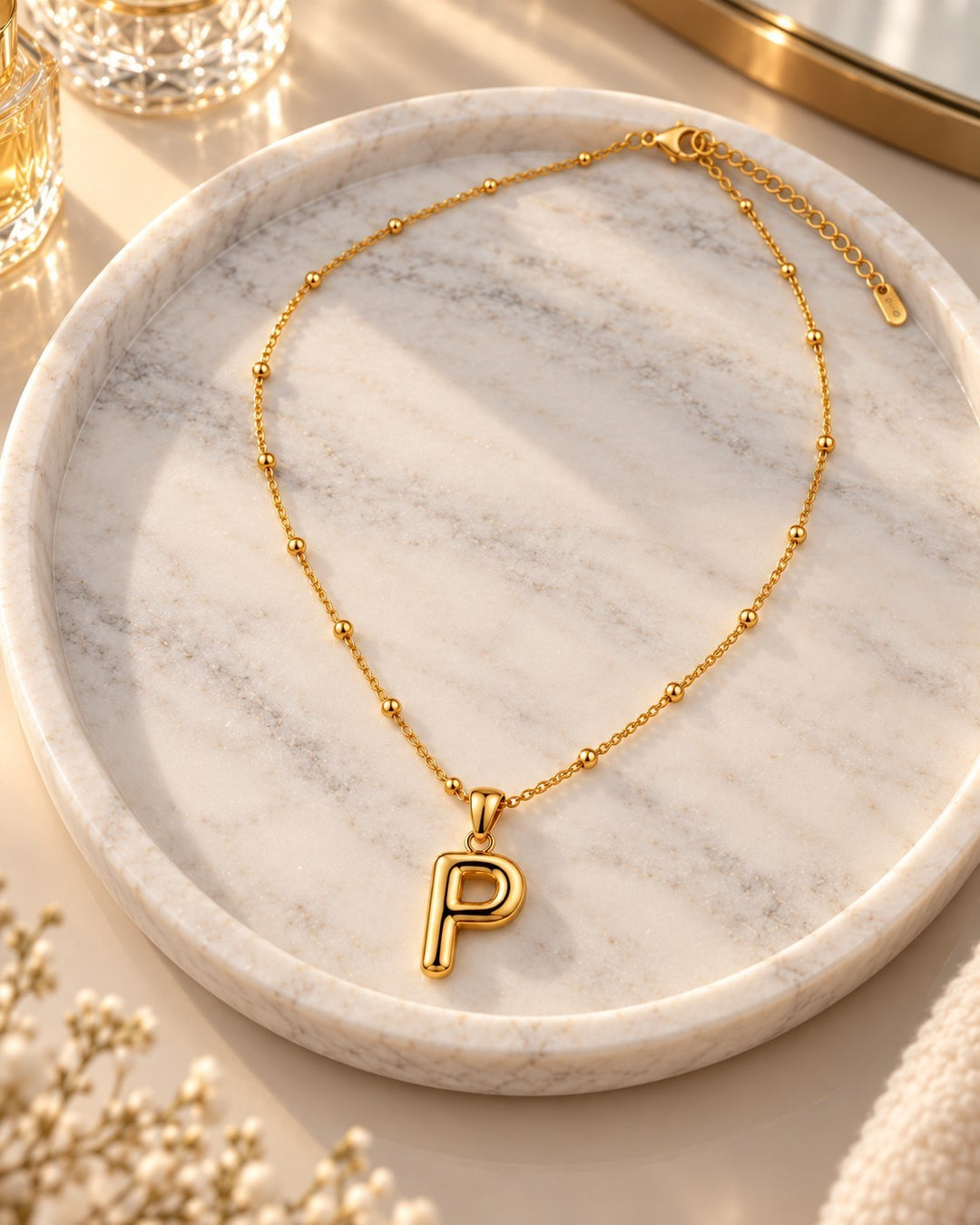 Elli Jewellery gold plated waterproof chunky initial P pendant necklace on a delicate beaded chain.