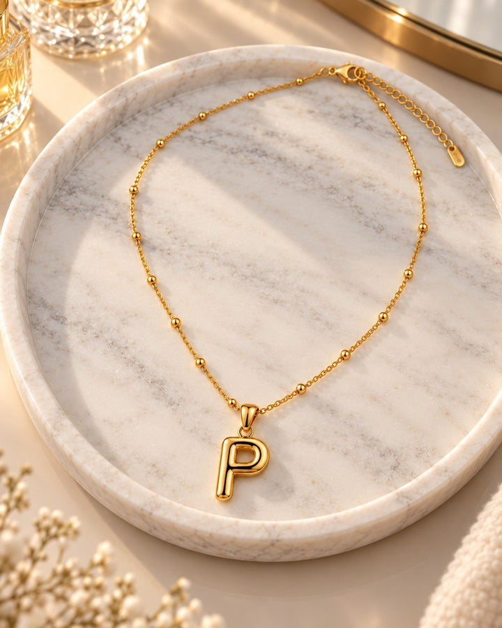 Elli Jewellery gold plated waterproof chunky initial P pendant necklace on a delicate beaded chain.