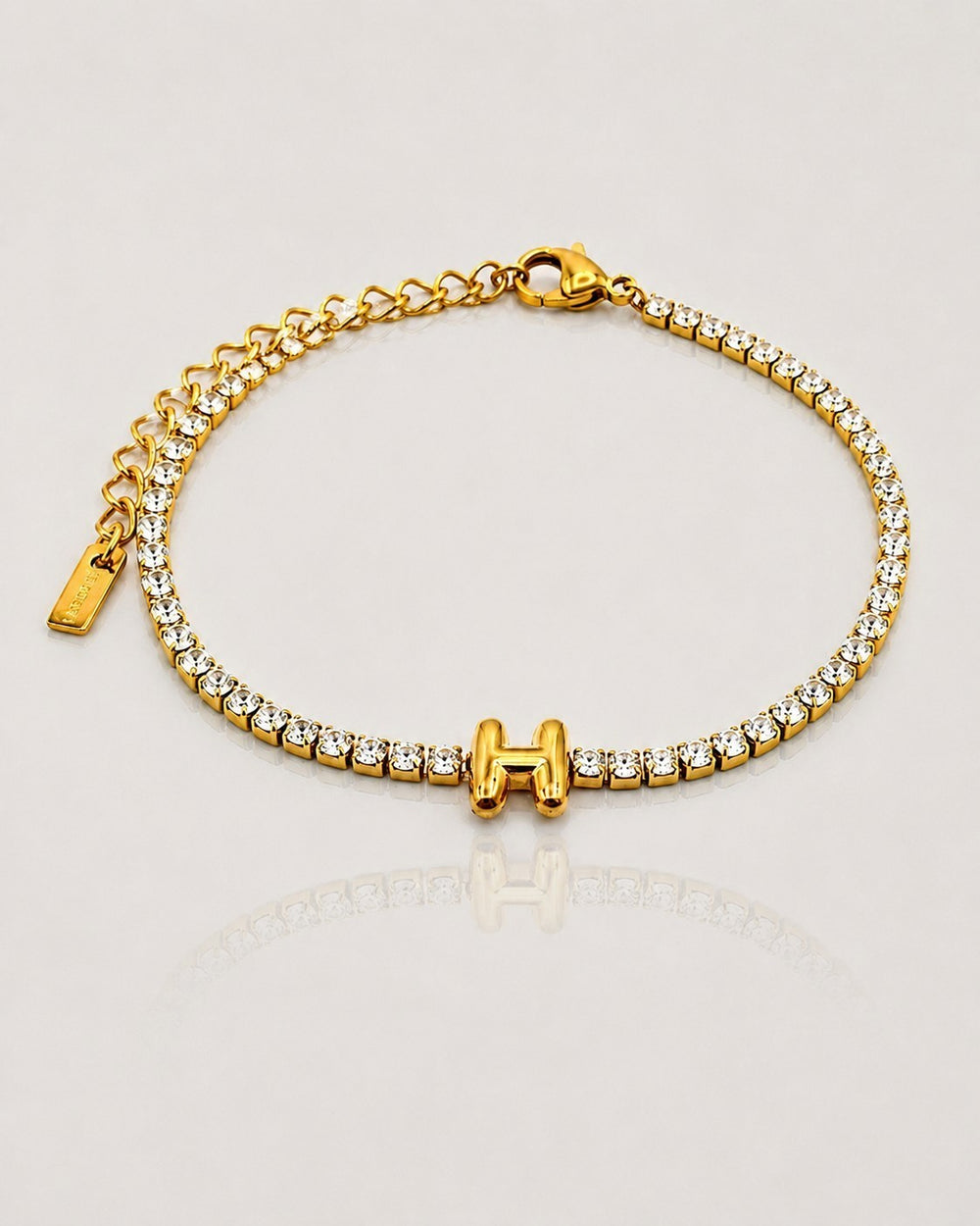 Elli Jewellery gold plated tennis bracelet featuring a letter H initial charm and sparkling clear crystals