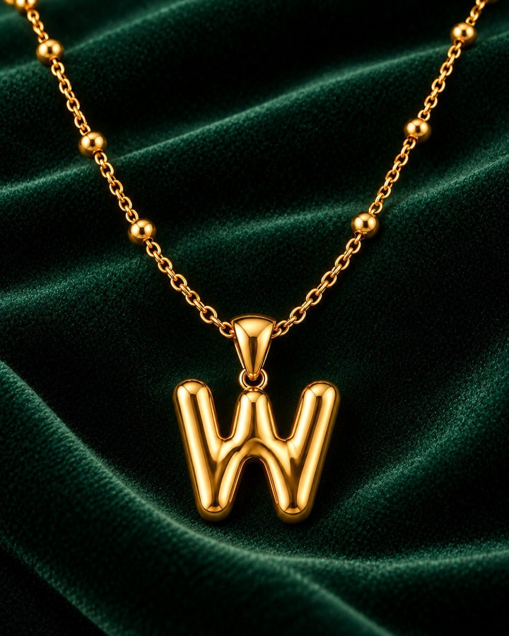 Elli Jewellery gold plated chunky chain necklace with a personalised letter W initial pendant on green velvet