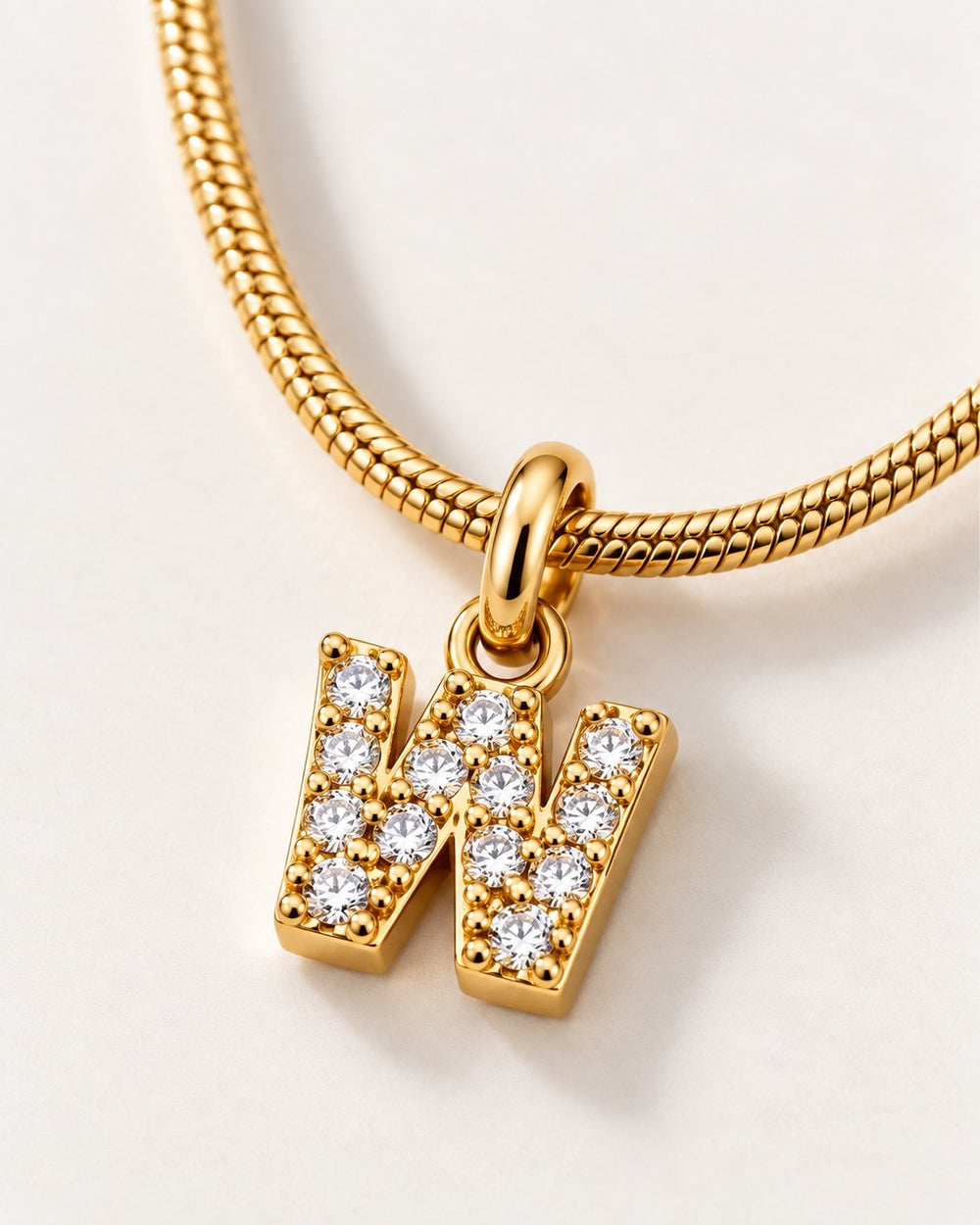 Elli Jewellery gold plated waterproof initial W pendant necklace featuring sparkling crystals on a snake chain
