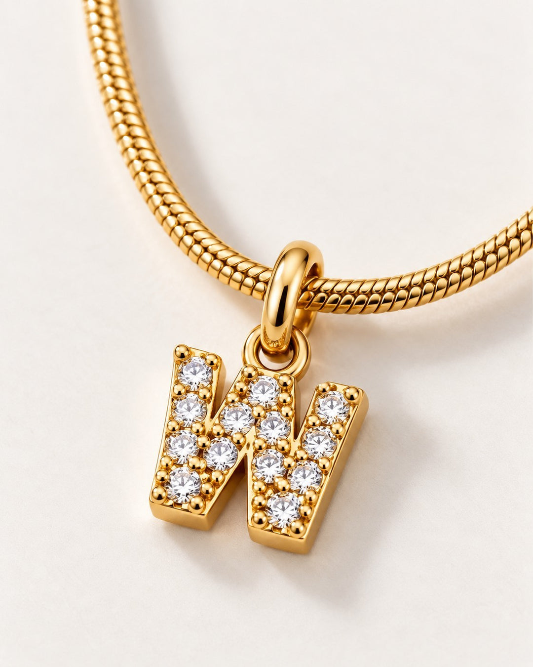 Elli Jewellery gold plated waterproof initial W pendant necklace featuring sparkling crystals on a snake chain