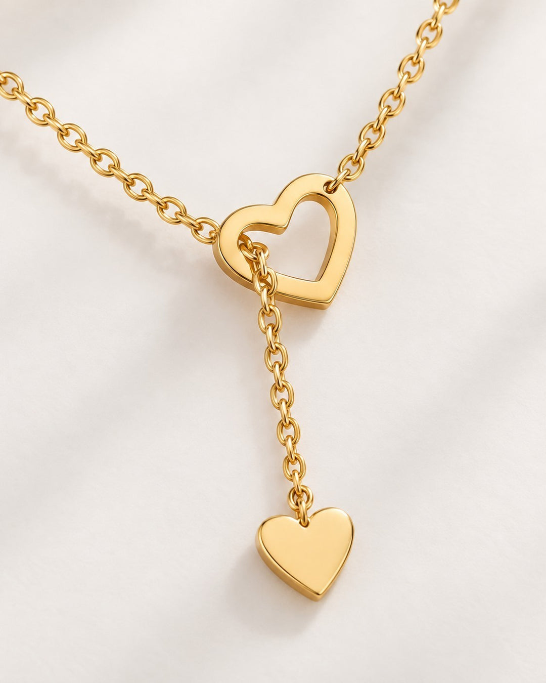 Elli Jewellery gold plated waterproof necklace featuring two interlocking hearts on a delicate threaded chain.