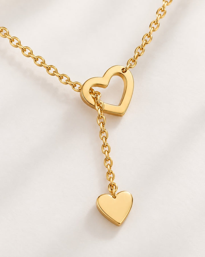 Elli Jewellery gold plated waterproof necklace featuring two interlocking hearts on a delicate threaded chain.
