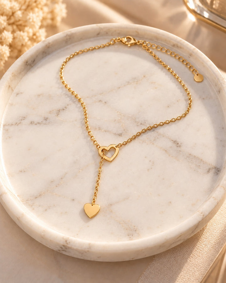 Elli Jewellery gold plated waterproof necklace featuring two interlocking hearts on a delicate threaded chain.