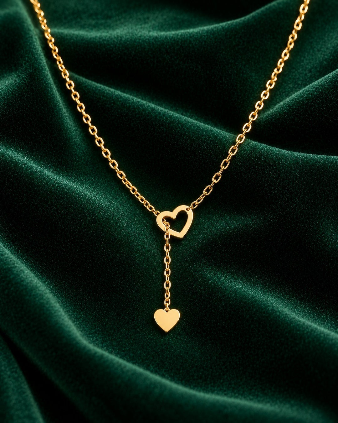 Elli Jewellery gold plated waterproof necklace featuring two delicate interlocking hearts on a sleek threaded chain.