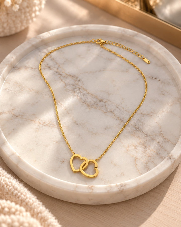 Elli Jewellery gold plated waterproof necklace featuring an intertwined double heart pendant on a delicate chain.