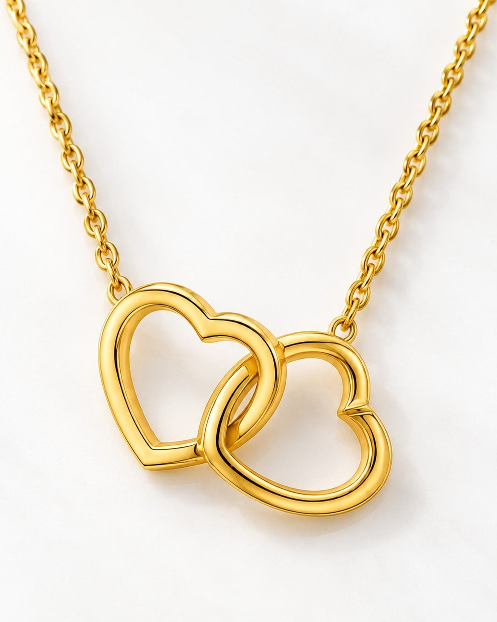 Elli Jewellery gold plated waterproof necklace featuring two delicate intertwined heart pendants on a fine chain.
