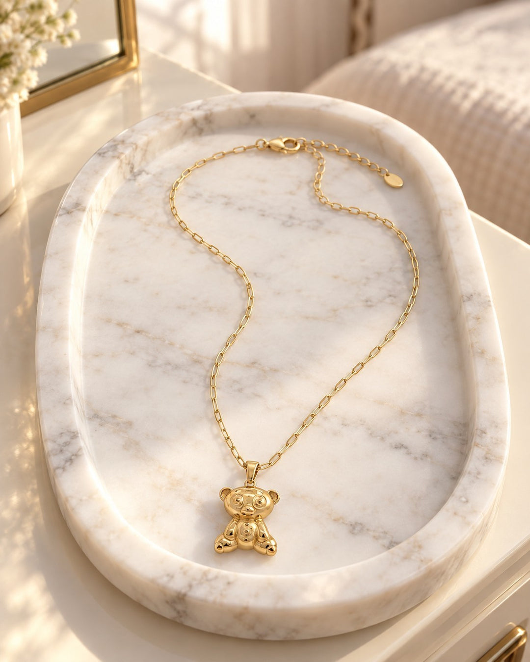 Elli Jewellery gold plated koala bear pendant necklace on a marble tray, featuring a delicate chain and cute design.