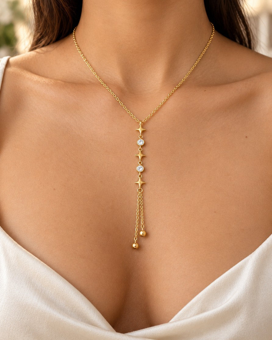 Elli Jewellery gold plated lariat necklace featuring star charms and clear crystals on a delicate chain