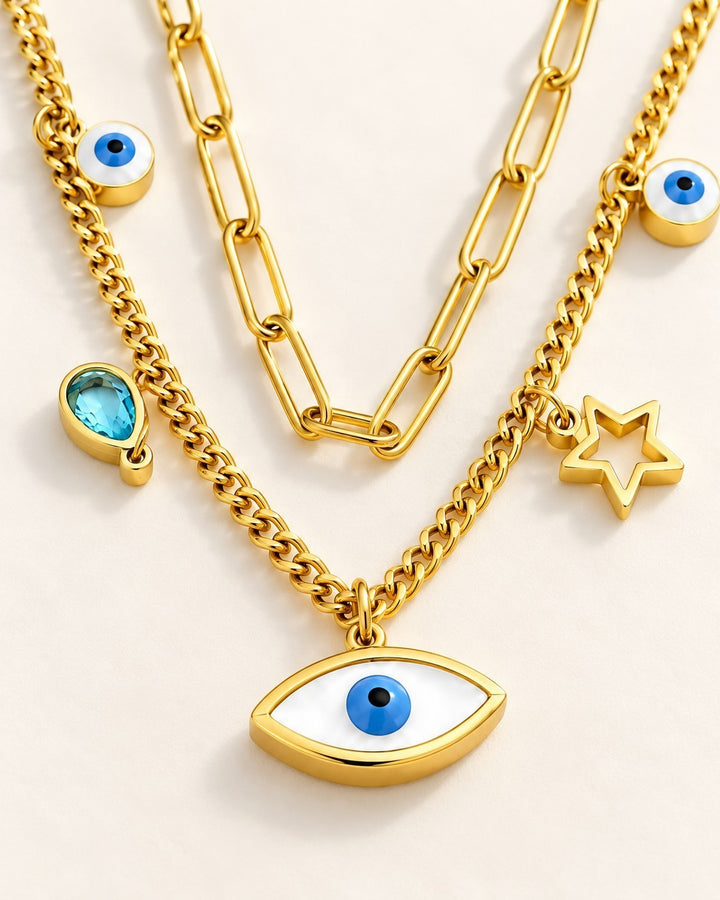 Elli Jewellery gold plated layered necklace with paperclip chain, evil eye charms, star pendant, and blue crystal.
