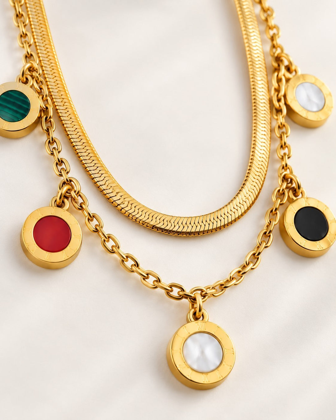 Elli Jewellery gold plated layered snake chain necklace with multicoloured circular charms on a white background