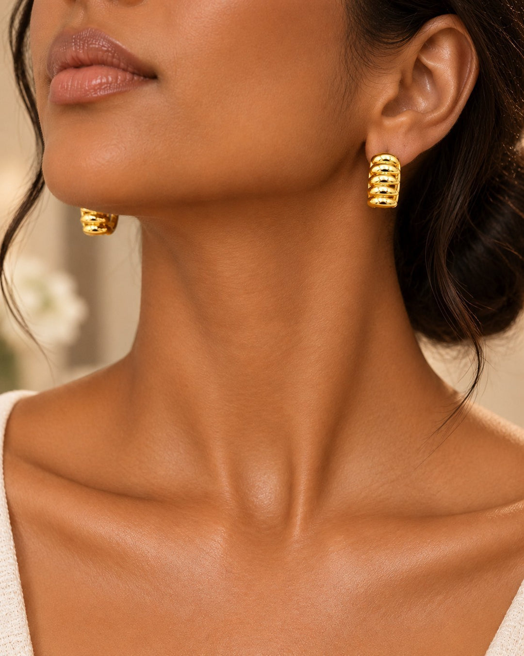 Elli Jewellery gold plated multi-layer stud earrings worn by a model, featuring a textured, stacked design.
