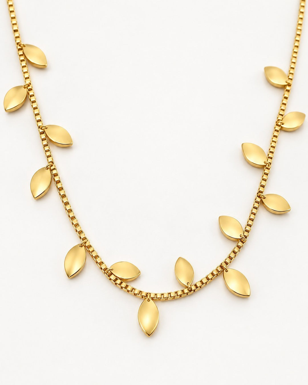 Elli Jewellery gold plated botanical leaf statement necklace with delicate box chain on a white background