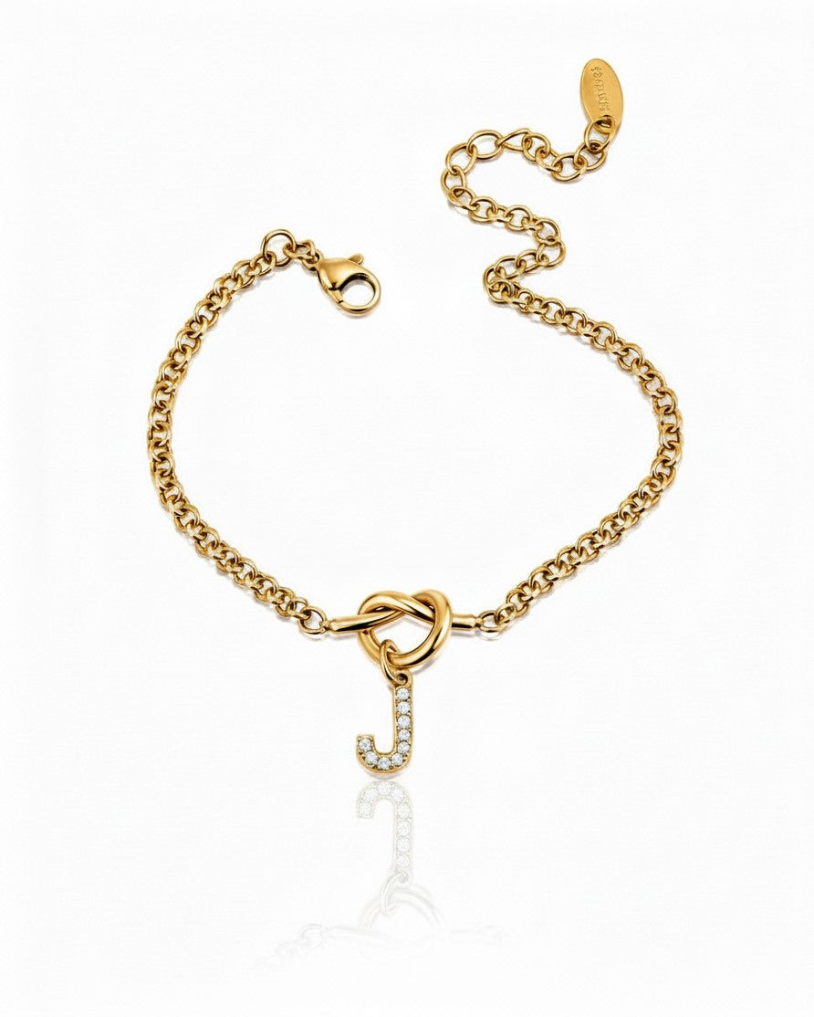 Elli Jewellery gold plated chain bracelet featuring a crystal-embellished letter J charm with a knot detail.
