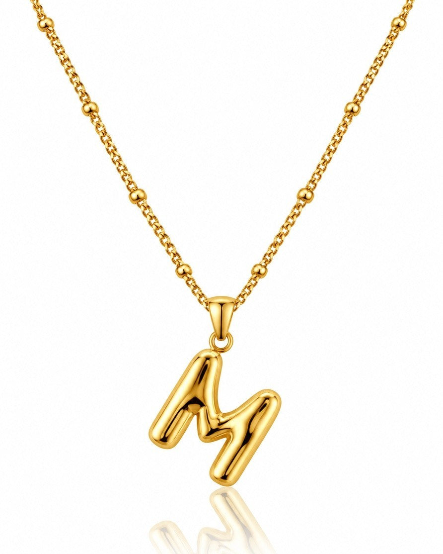Elli Jewellery gold toned chunky letter M pendant necklace on a delicate beaded chain, waterproof and tarnish-free.