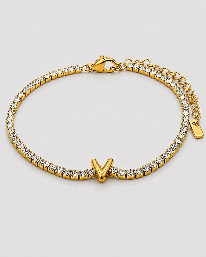 Elli Jewellery gold plated tennis bracelet featuring a letter V initial charm and sparkling clear crystals.