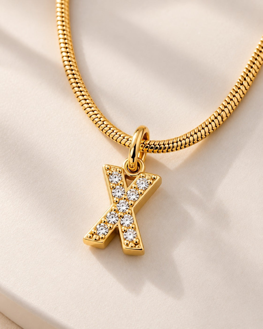 Elli Jewellery gold plated letter X initial pendant necklace with sparkling crystals on a delicate snake chain