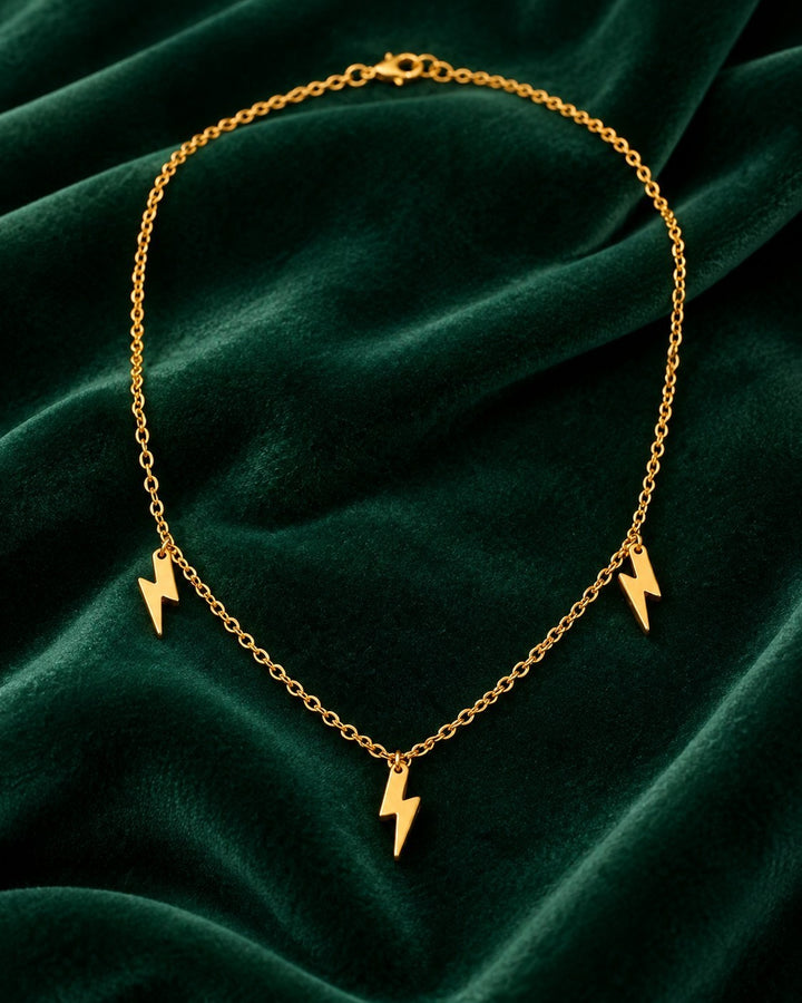 Elli Jewellery gold plated waterproof necklace featuring three small lightning bolt charms on a delicate chain